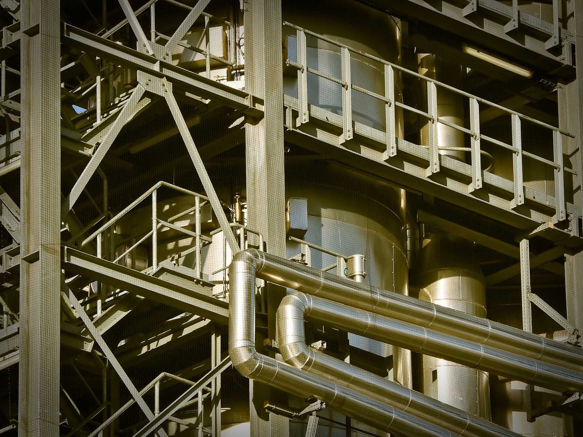 Stainless steel tanks, piping and process structure inside a production plant